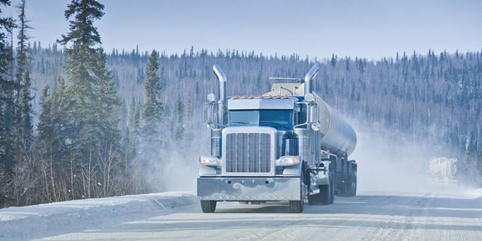 A truck travel in winter snowy road
